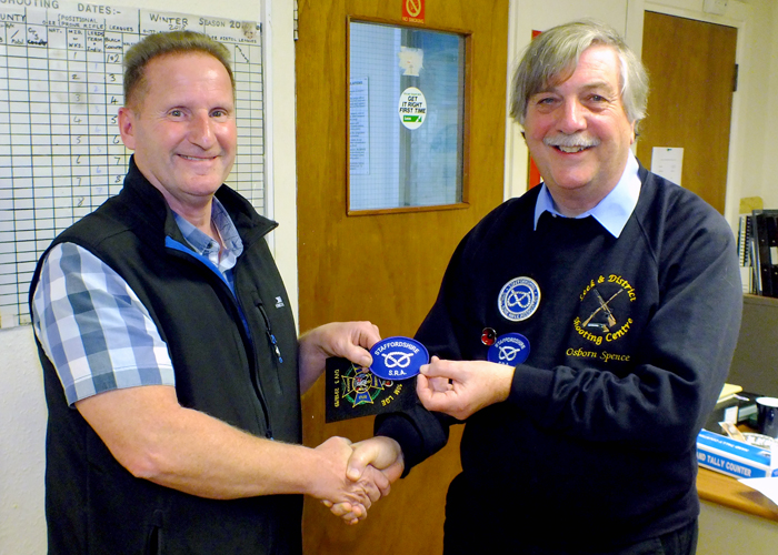 Photograph shows Osborn Spence - SSRA Airgun Secretary (pictured right) presenting the NSRA (680) Inter-County Air Pistol League - Division 3 - 2018/2019 - Winners Blazer Badge to Staffordshire Team Member Dave Hill (pictured left).