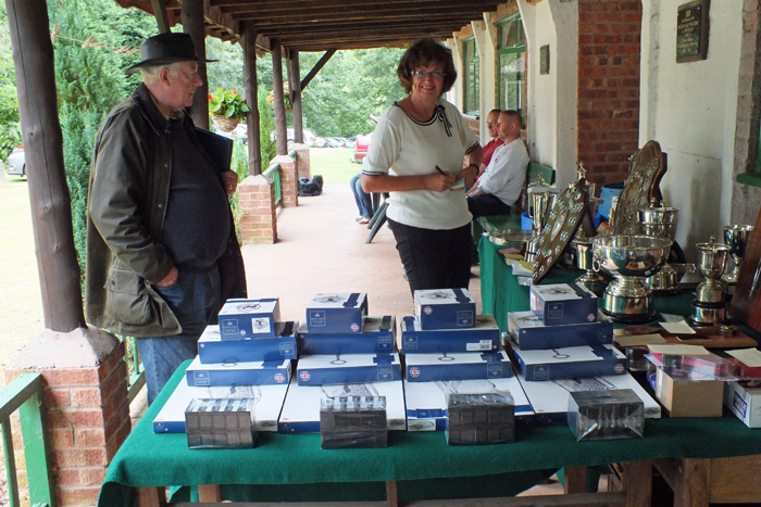 Photograph shows Dave Bayley (pictured left) and Judith Simcock (pictured centre) setting out the trophies at the SSRA Combined Open Squadded Rifle Meeting 2013.