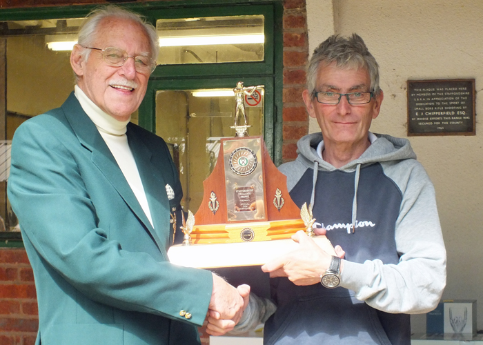 Photograph shows SSRA President - Major (Retired) Peter Martin MBE, pictured left - presenting the 50 Metres Trophy to B. Tonks, pictured right.