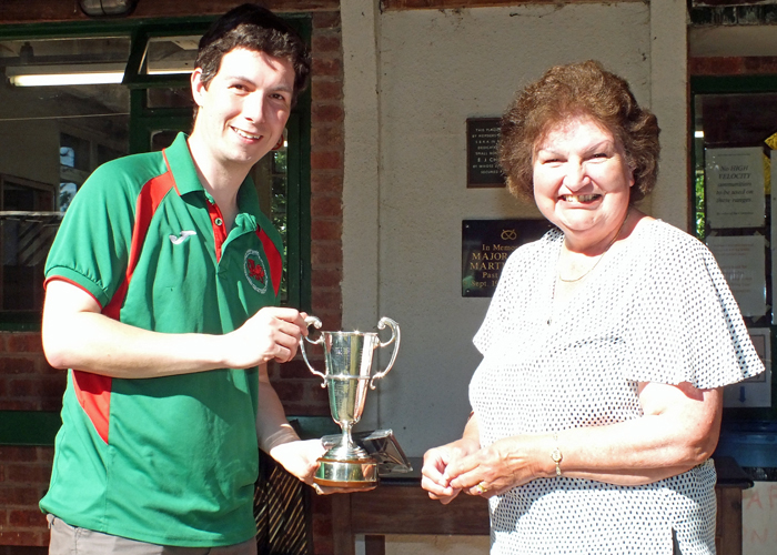 Photograph shows Mrs. Janet Troke (pictured right), presenting the Miniature Rifle Cup to Richard Hemingway (pictured left).