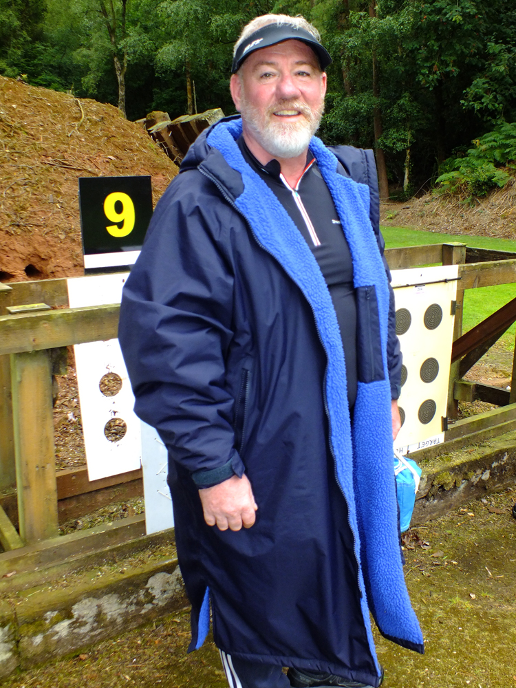 Photograph shows a snuggly wrapped-up Martyn Buttery about to return to the firing line after having fixed his targets to the frames on the 50 metres range.
