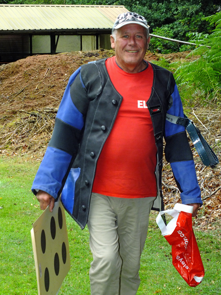 Photograph shows Graham Delaney keenly setting off, on his way downrange, targets in hand.
