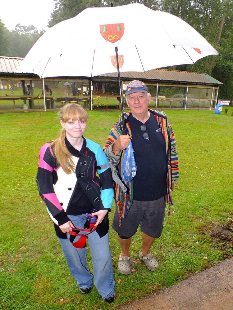 Photograph shows a brave pair of souls, Phoebe Houghton (pictured left) and Lee Featherstone (pictured right),  making their way back from the firing line, trying to evade the downpour!