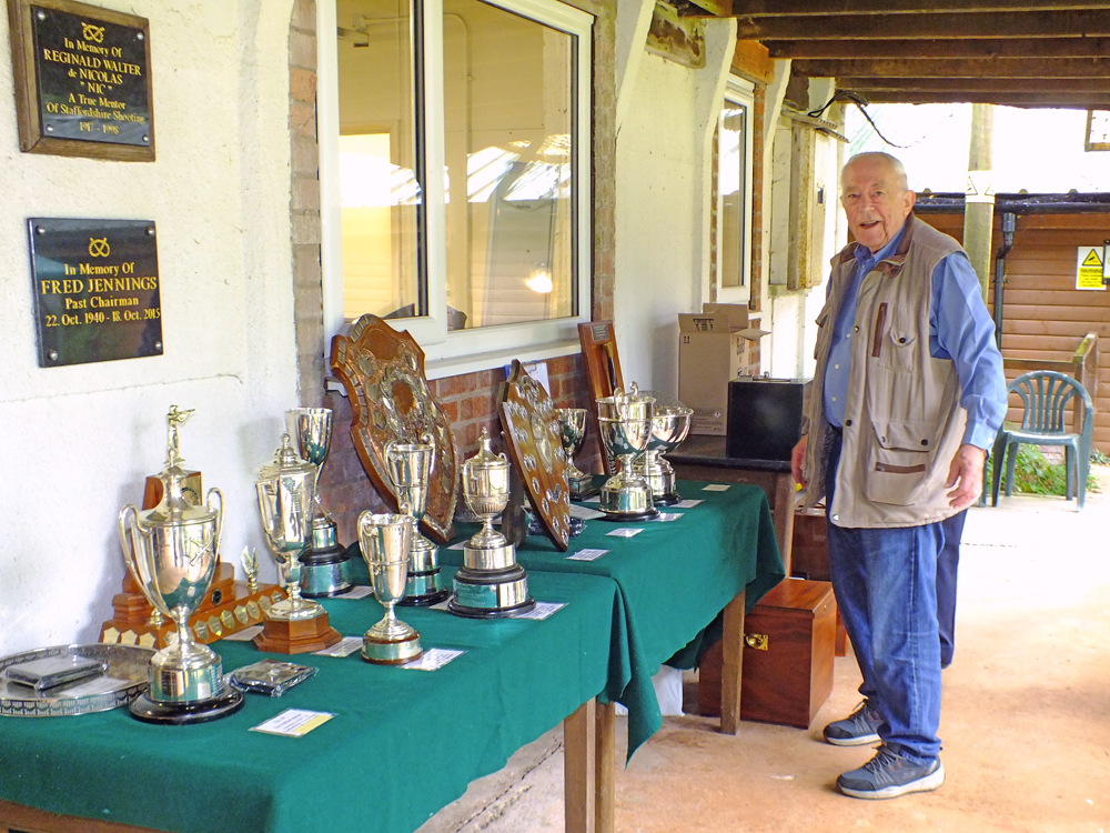 Photograph shows Dave Bayley admiring the fabulous display of trophies that were up for grabs on the day.