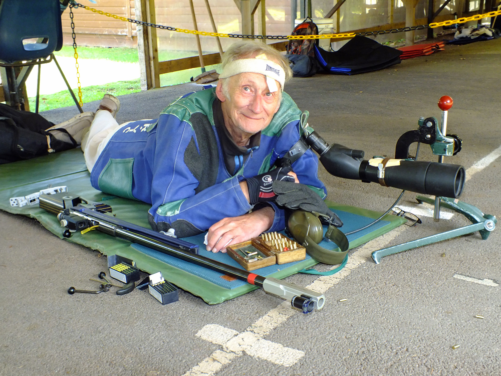 Photograph shows Vic Tyne, relaxed and waiting patiently on the firing line, all set to get cracking on his fresh set of targets.