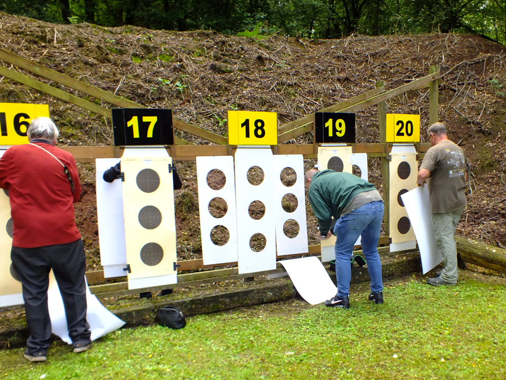 Photograph shows - (left to right) - Ian Abbotts, Wayne Kirkland, and Dave Glover - busily affixing targets on the 100 yards range.