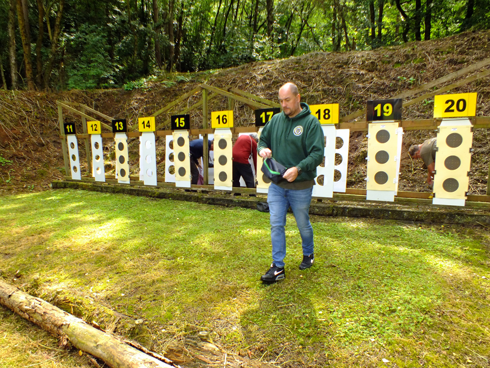 Photograph shows Wayne Kirkland making his way back to the firing line after setting-up Olivia Kirkland's 100 yards targets.
