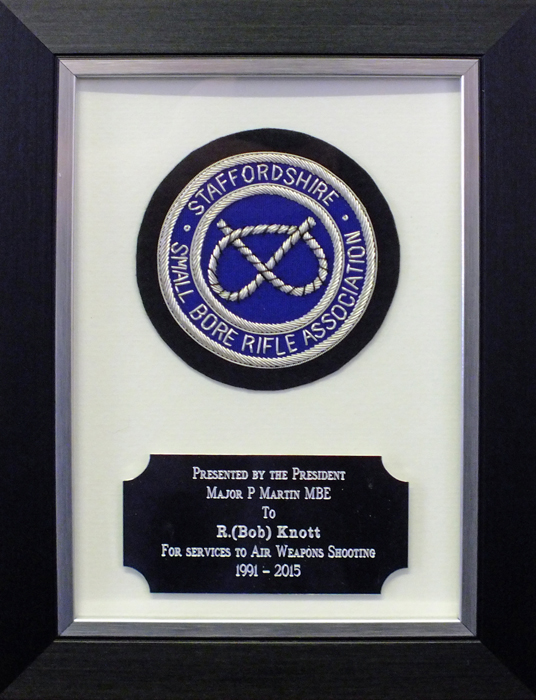Photograph shows the 'Special Award For Services To Air Weapons Shooting' plaque presented to Robert Knott.