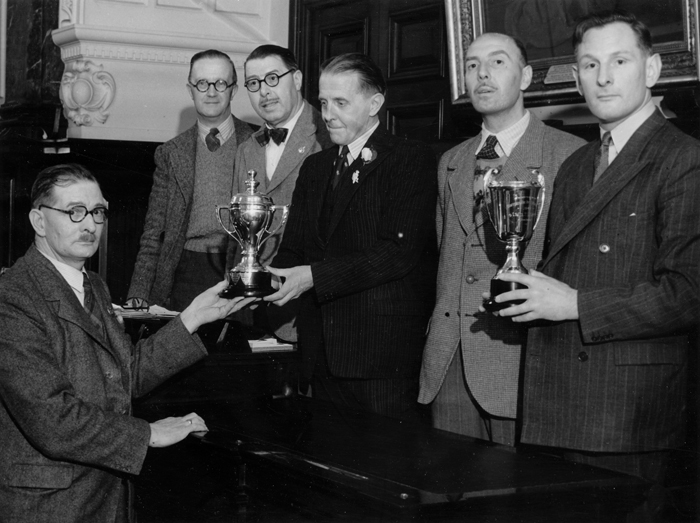 Photograph shows Edward John Chipperfield presenting various trophies.