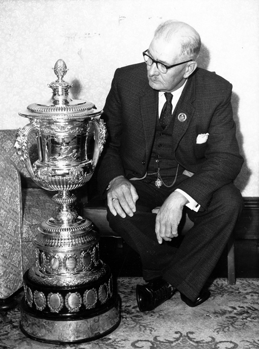 Photograph shows Edward John Chipperfield admiring the Queen Alexandra Cup.