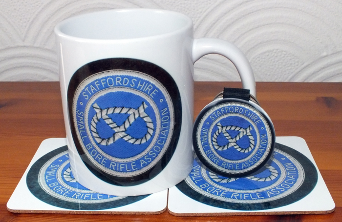 Photograph shows an SSRA Ceramic Mug, together with an SSRA Key ring.