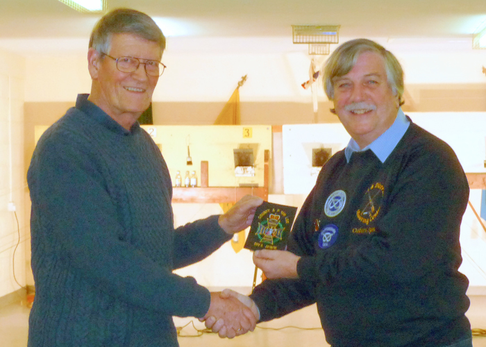Photograph shows Osborn Spence - SSRA Airgun Secretary (pictured right) presenting the NSRA (680) Inter-County Air Pistol League - Division 3 - 2018/2019 - Winners Blazer Badge to Staffordshire Team Member Vic Jagiello (pictured left).