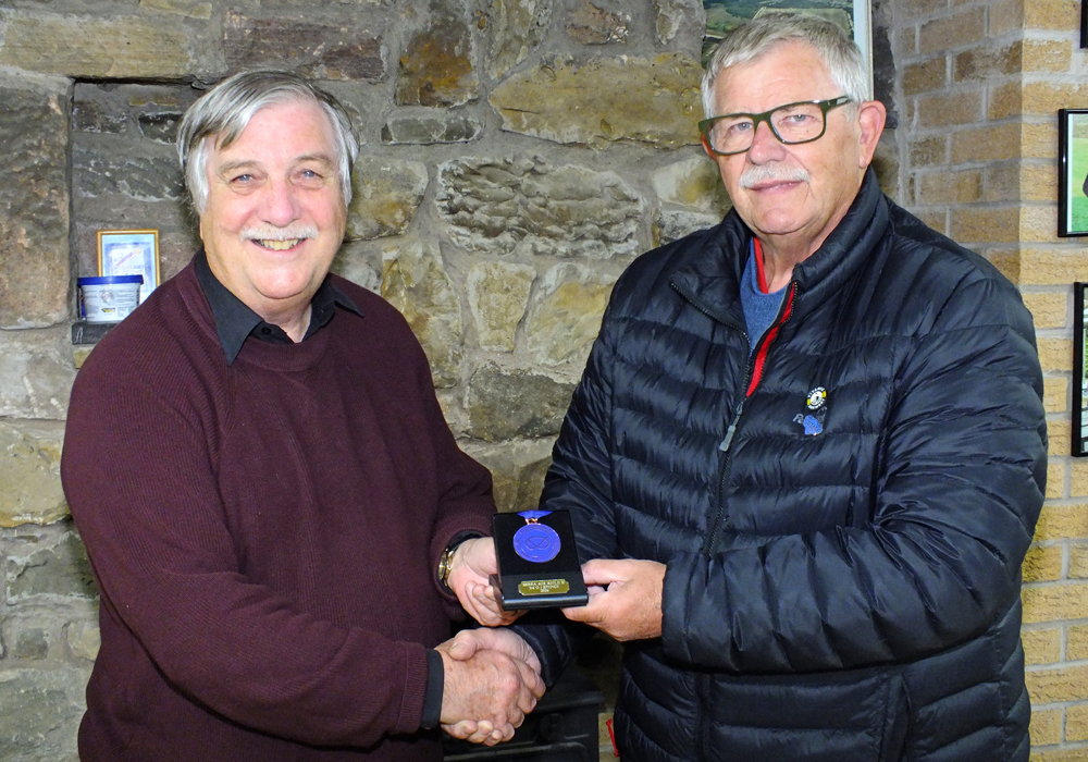 Phe above photograph shows Osborn J Spence of Leek and District Shooting Centre (pictured left) receiving his SSRA Individual 10 Metres Air Rifle - 'B' League - Summer 2026 - 3rd Place Medal from Mike Peacock of Leek and District Shooting Centre (pictured left).