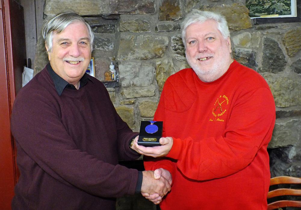 Photograph shows Paul D Barker of Leek and District Shooting Centre (pictured right) receiving his SSRA Individual 10 Metres Air Rifle - 'A' League - Summer 2026 - 3rd Place Medal from Osborn J Spence of Leek and District Shooting Centre (pictured left).