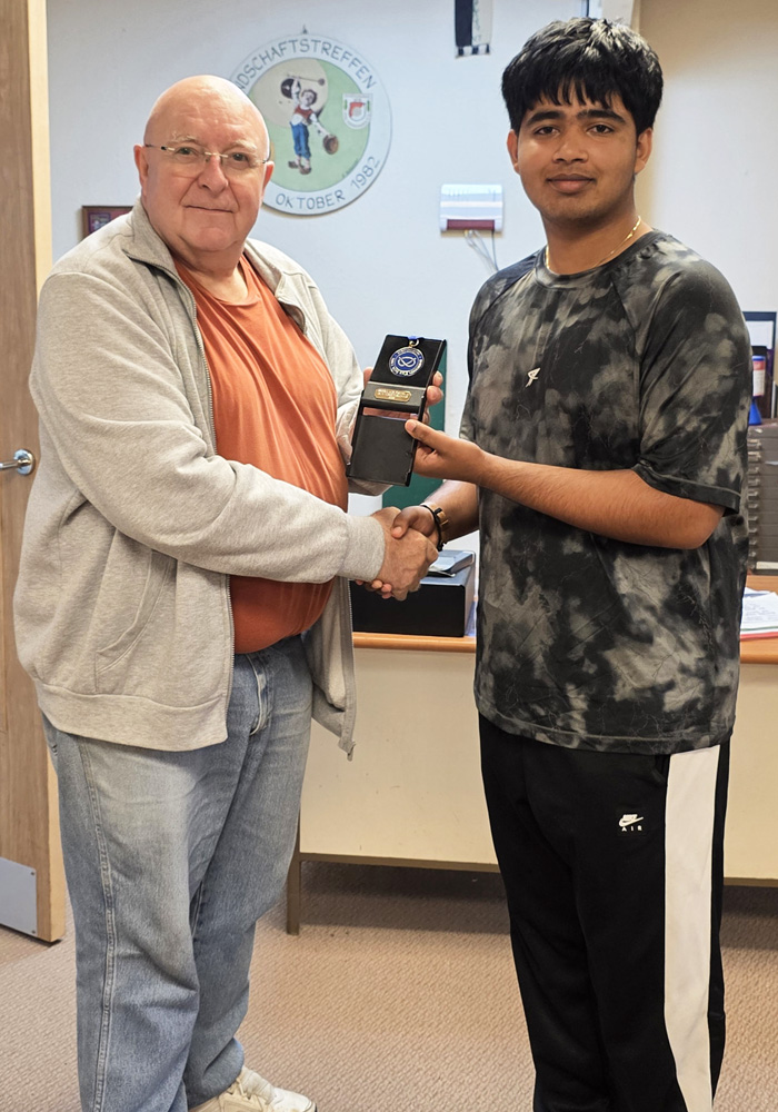 Photograph shows Vinaykumar Vinothkumar of Sutton Coldfield Rifle and Pistol Club (pictured right) receiving his SSRA Individual 10 Metres Air Pistol - 'A' League - Summer 2026 - 1st Place Medal from Paul Stokes of Sutton Coldfield Rifle and Pistol Club (pictured left).