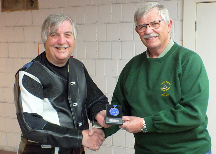 Photograph shows Osborn J Spence of Leek and District Shooting Centre (pictured left) receiving his SSRA Individual Air Pistol League - 2nd Place Medal from Mike Peacock of Leek and District Shooting Centre (pictured right).