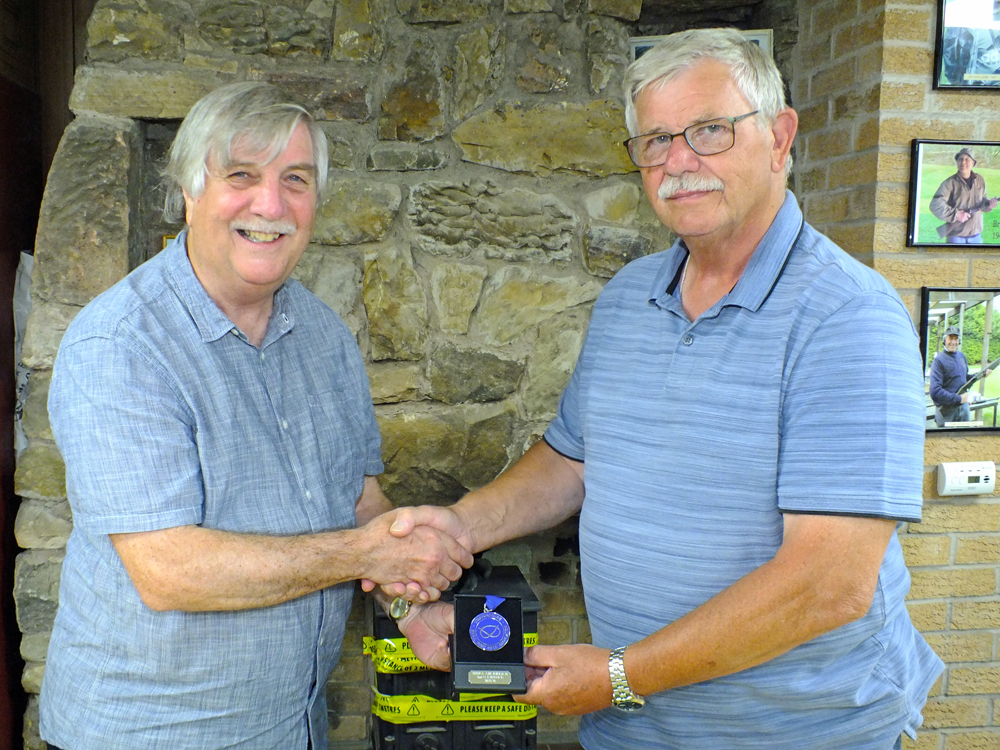 Photograph shows Osborn J Spence of Leek and District SC (pictured left), receiving his SSRA Individual 10 Metres Air Rifle 'B' League - Winter 2025/2026 - 2nd place medal from Mike Peacock of Leek and District SC (pictured right).