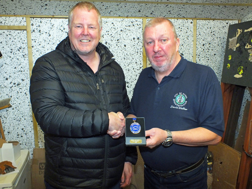 Photograph shows Dom Paskin of City of Stoke RPC (pictured left) receiving his SSRA Individual Air Pistol League - Summer 2025 - 1st Place Medal from Dave Walker of City of Stoke RPC (pictured left).
