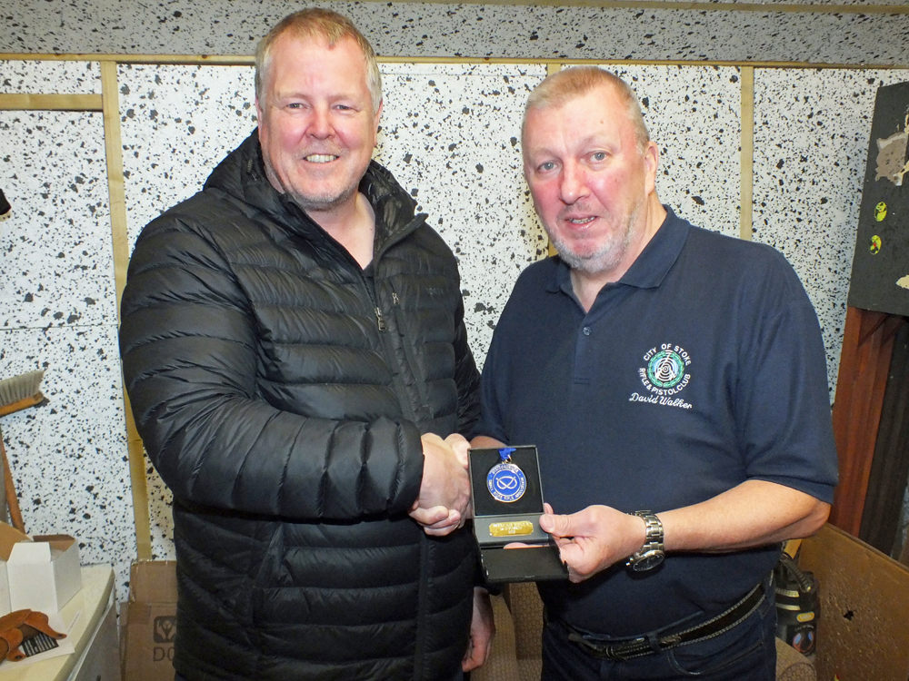 Photograph shows Dom Paskin of City of Stoke RPC (pictured left) receiving his SSRA Individual Air Rifle - B League - Summer 2025 - 1st Place Medal from Dave Walker of City of Stoke RPC (pictured left).