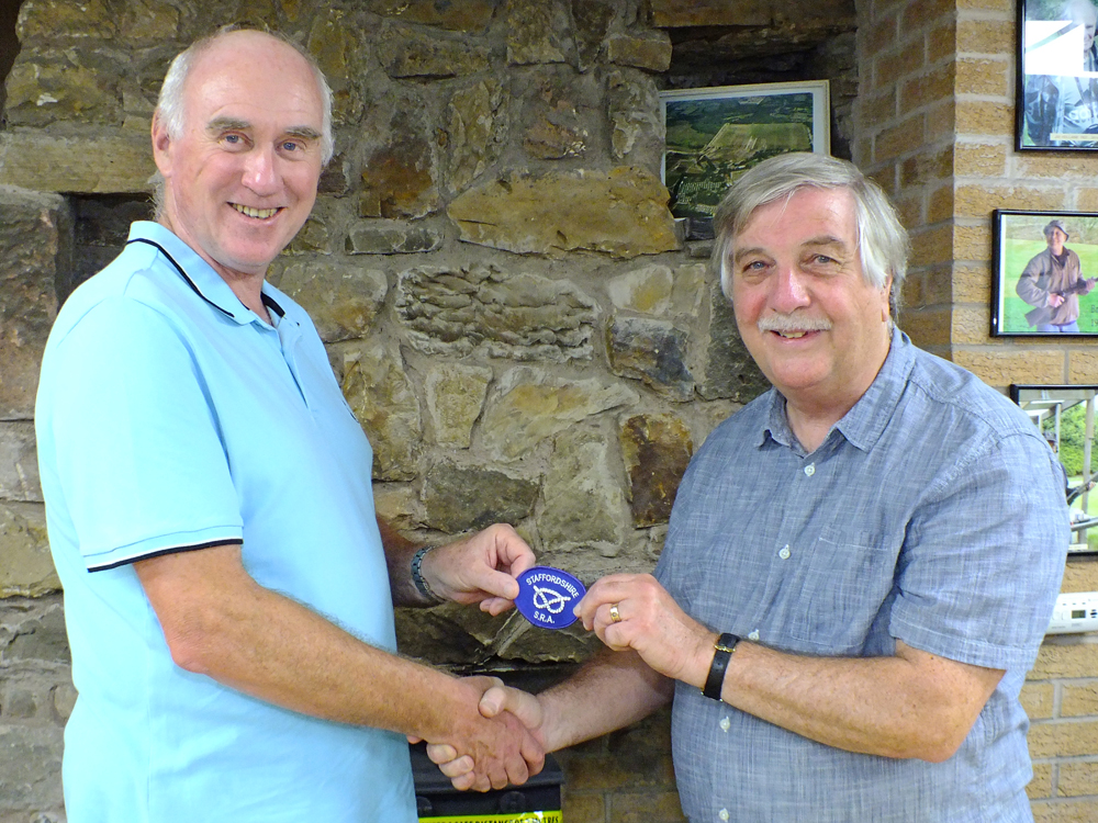 Photograph shows Osborn J Spence - SSRA Airgun Secretary (pictured right) presenting the Staffordshire Inter-County Team Badge to Staffordshire 10 Metres Air Pistol Team Member John Cooper of Leek and District Shooting Centre (pictured left) for completing his first full season representing Staffordshire at Inter-County level.