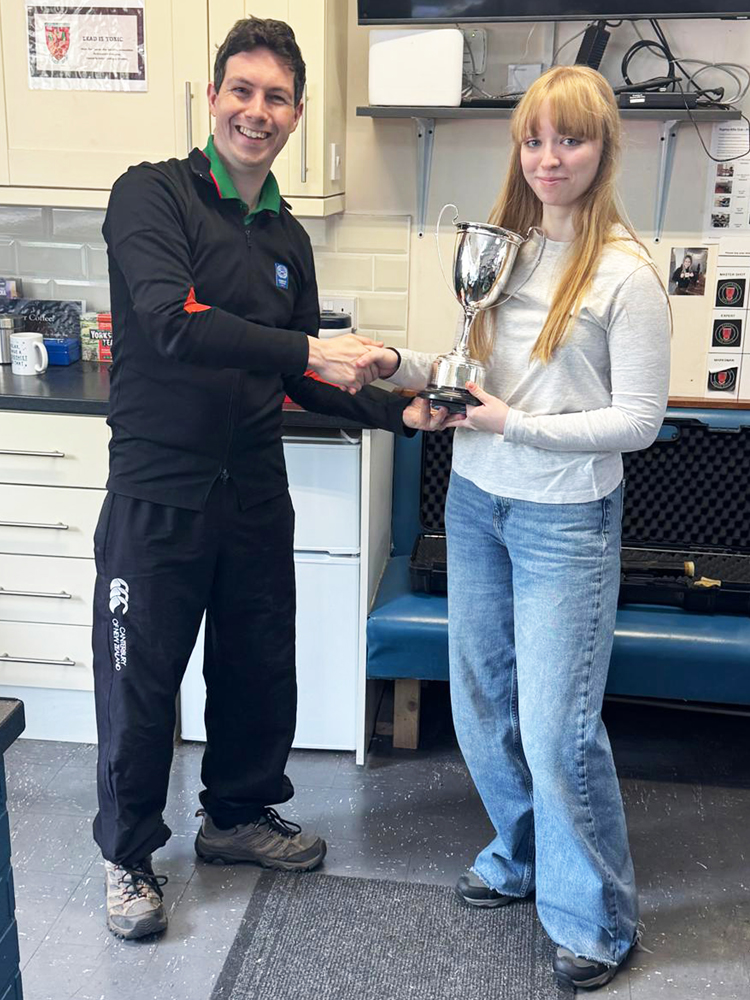 Photograph shows Phoebe Houghton of Rugelely RPC (pictured right) receiving the Cliff Everall Memorial Cup from Richard Hemingway (pictured left).