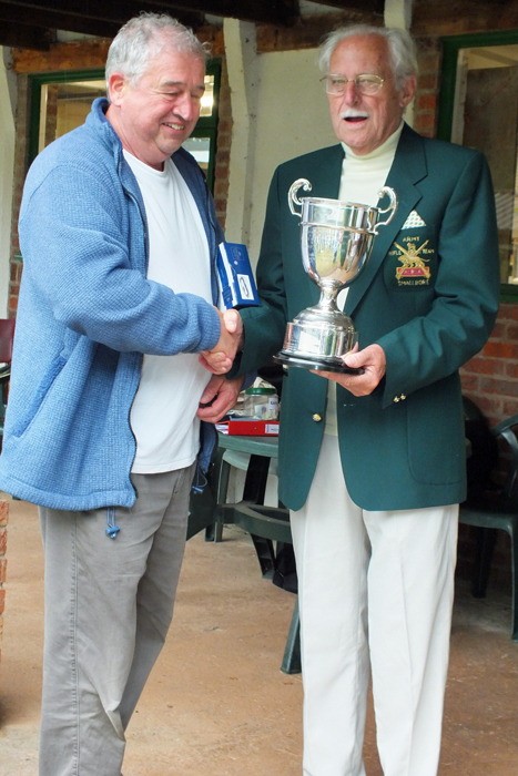 Photograph shows J. Wilshaw, pictured left, receiving The R.W. De Nicolas Memorial Trophy from SSRA President - Major (Retired) Peter Martin, MBE.