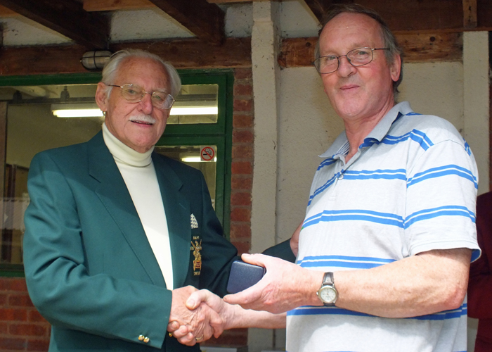 Photograph shows SSRA President - Major (Retired) Peter Martin MBE, pictured left - presenting the NSRA County Silver Medal to G. Abbotts, pictured right.