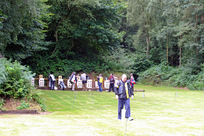 Photograph shows competitors changing their targets on the 50 metre range.