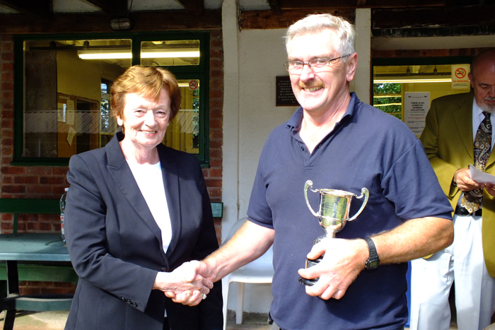 Photograph shows Mary Jennings, pictured left, presenting the Association Cup to Peter Dean, pictured right.