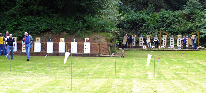 Photograph shows competitors changing their targets on the 50 metre range, and on the adjacent 100 yard range.