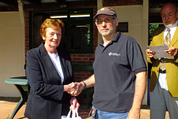Photograph shows Mary Jennings, pictured left, presenting the Class A 3rd Place Prize to Mike Arnstein, pictured right.