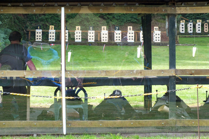Photograph shows the view from behind the firing points with the competitors in action.