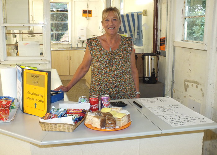 Photograph shows Nikki Thacker awaiting the rush for her excellently prepared food and refreshments.