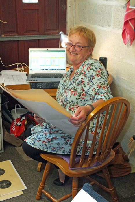 Photograph shows Debbie Round - Clerk to the Scorers - busily compiling the scores on the computer.
