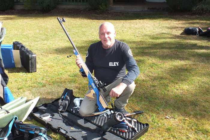 Photograph shows Graham Delaney displaying his rifle as he prepares for his detail.