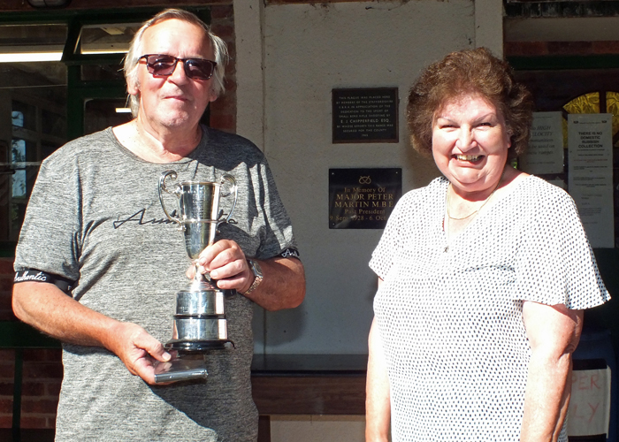 Photograph shows Mrs. Janet Troke (pictured right), presenting the Moat Cup to Ian Abbotts (pictured left).