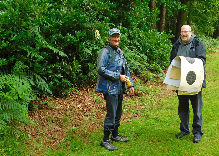 Photograph shows two chaps having a stroll down the range.