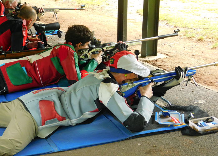 Photograph shows competitors on the firing line as the competition heats up.