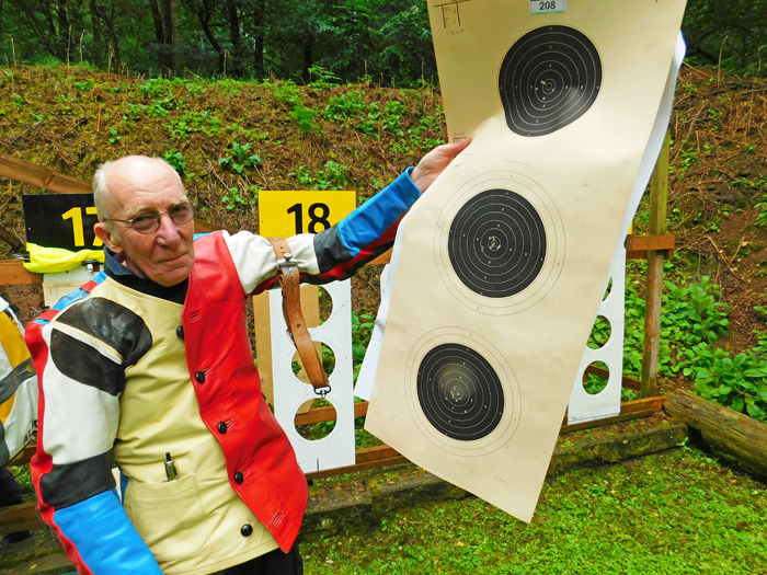 Photograph shows Steve Rowe proudly displaying his shot targets.