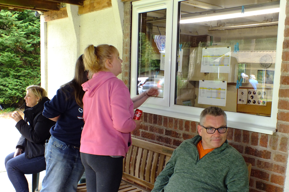 Photograph shows competitors eagerly searching for their latest scores which were published on the clubhouse window. Surely that's not right ... is it?  Maybe it is!