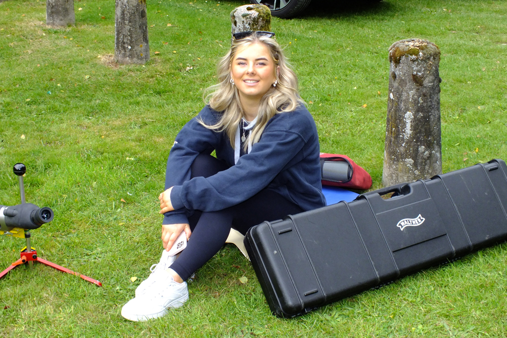 Photograph shows the previously mentioned young lady, now fully relaxed after the successful repair to her spotting scope.