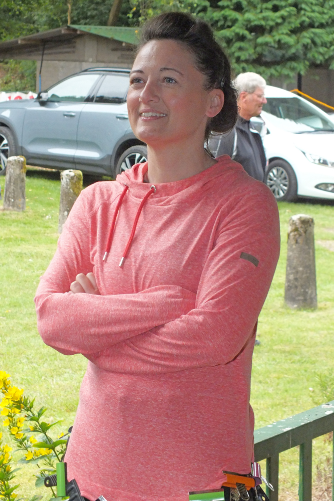 Photograph shows Natasha Minikin deep in conversation, in the shade of the clubhouse veranda.