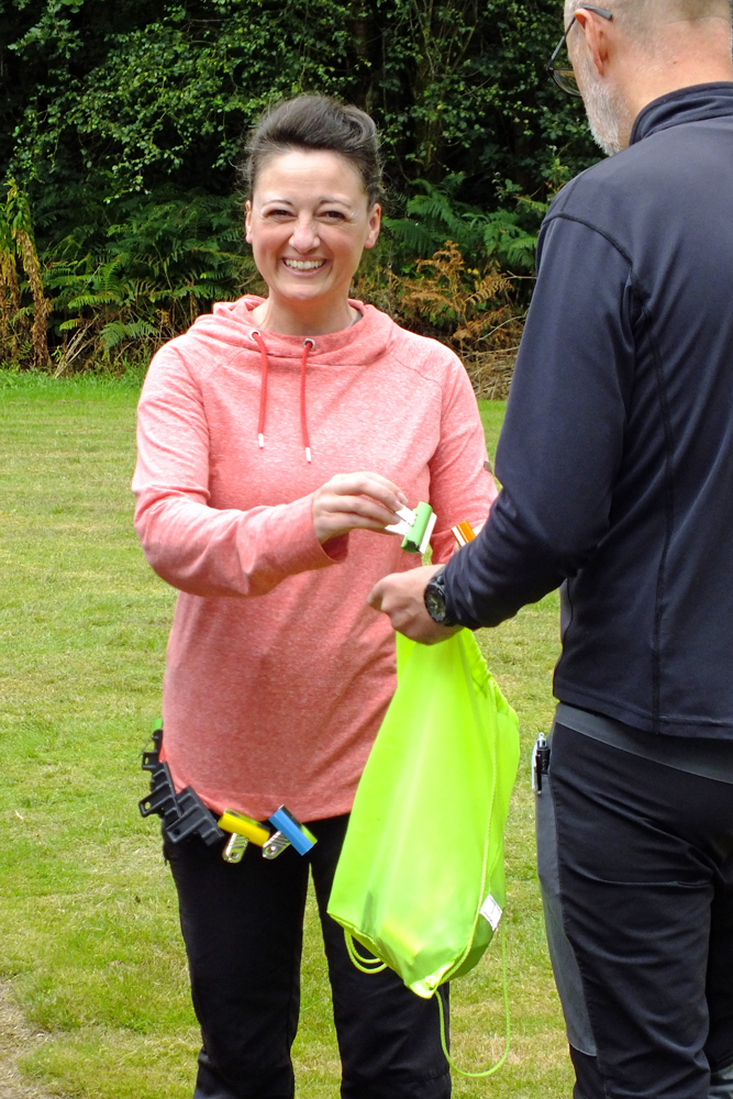 Photograph shows Natasha Minikin removing some wonderfully colourful Bulldog Clips from the hem of her hoodie! This has got to be the latest fashion craze!