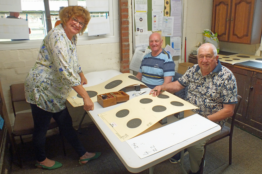 Photograph shows Judith Simcock (pictured left), Jeff Hickson (pictured centre), and John Wilshaw (pictured right) - members of the scoring team, doing what they do best!