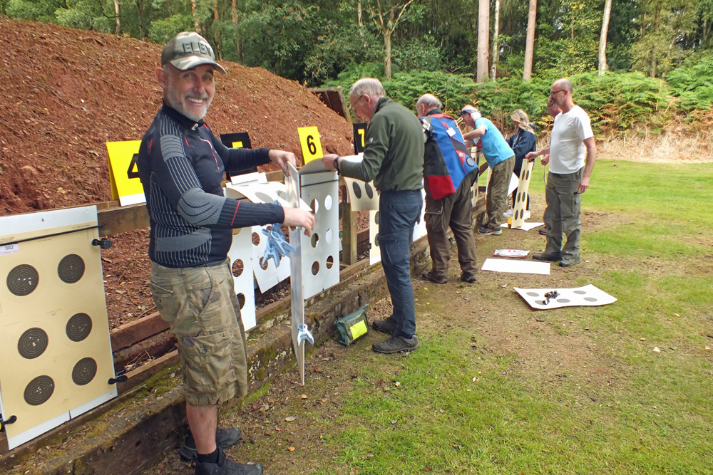 Photograph shows the frenzied activity at the end of the 50 metres range as the competitors change their targets.