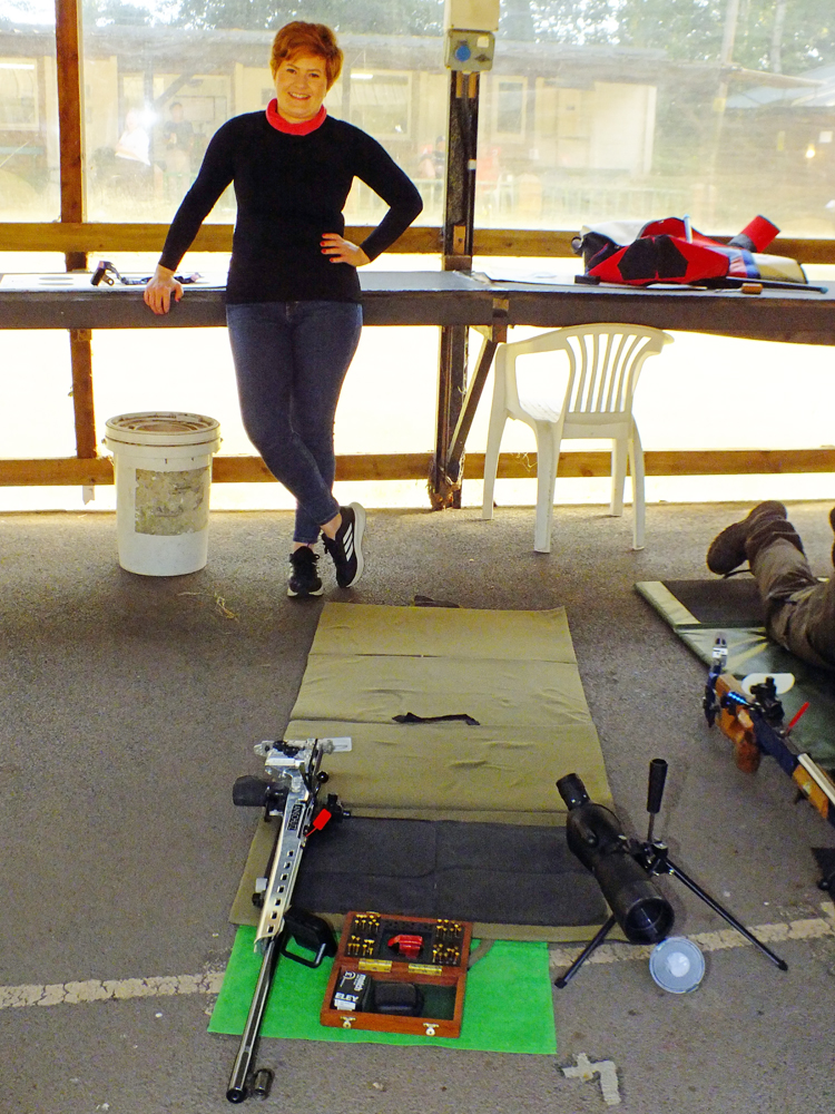 Photograph shows Amy Simcock calmly relaxing on the firing line, waiting to start her detail.