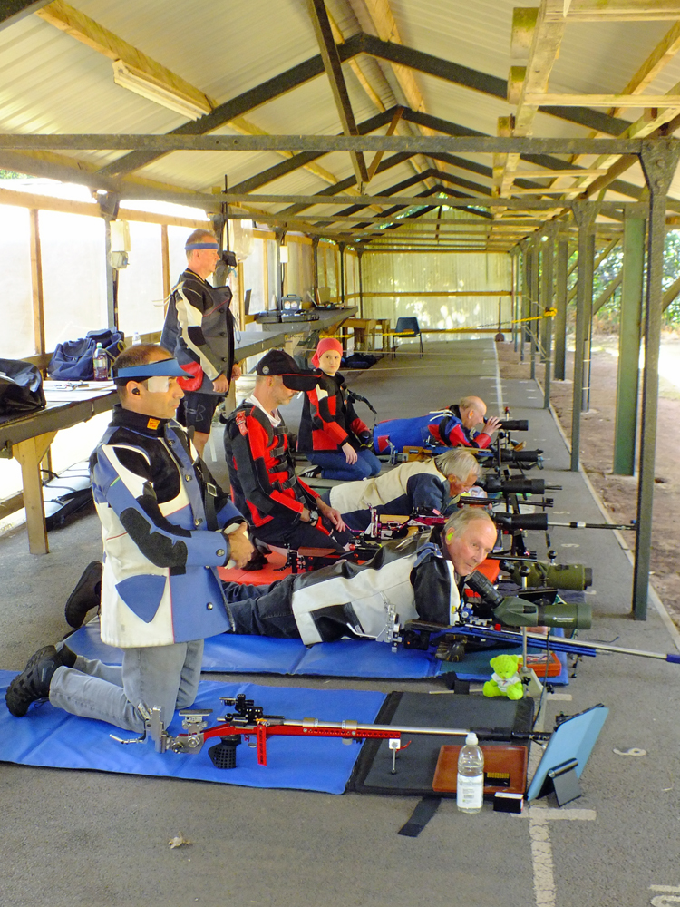 Photograph shows competitors on the firing line, all ready to 'get cracking' ... especially when the sound of live firing is soon to be heard!