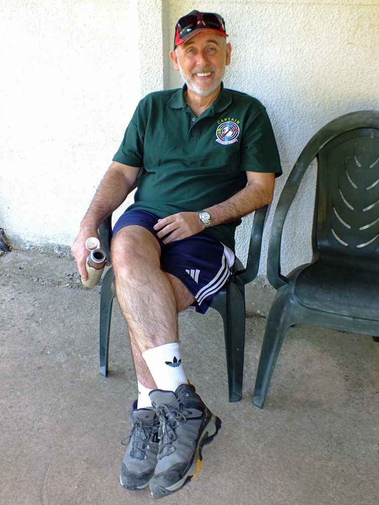 Photograph shows a relaxed Gavin Scott-Brooker, also taking time-out under the veranda.