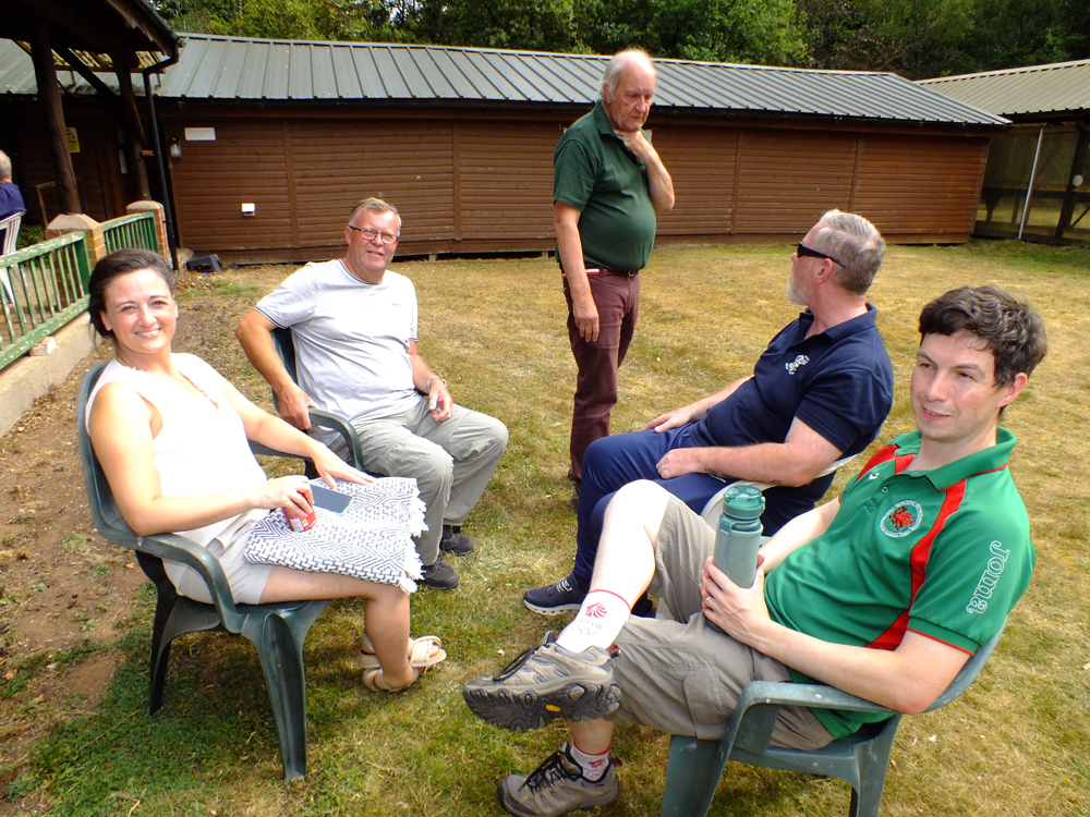 Photograph shows that once all the shooting is done for this group, it's time to relax and await the presentations!