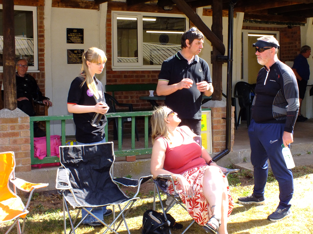 Photograph shows a group deep in conversation, no doubt reviewing their previous shooting details.
